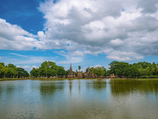 Fototapeta na wymiar Ruin of Pagoda and statue reflection in the water At sukhothai historical park,Sukhothai city Thailand