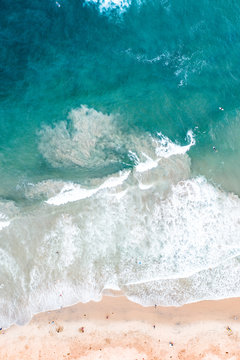 Aerial of beach waves crashing on the shore