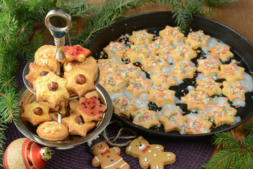 baked Christmas cookies on wooden table with christmas decoration.