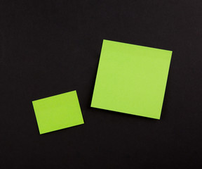 Green Blank Sticky Note on black background , Two paper sheet background. Big and small task Copy Space.