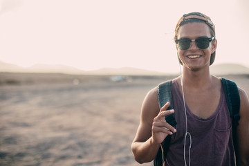 Portrait Of Young Handsome cheerful guy in sunglasses on the roadside.