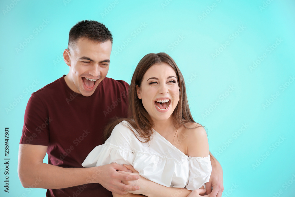 Sticker happy young couple on color background