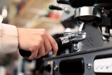 Fototapeta na wymiar Barista preparing coffee using modern machine, closeup