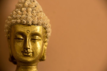 A buddha figure with an orange background