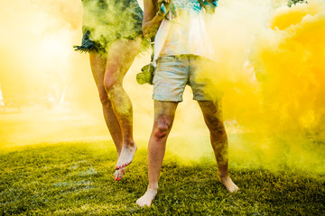 Man an woman caught in the middle of yellow paint clouds