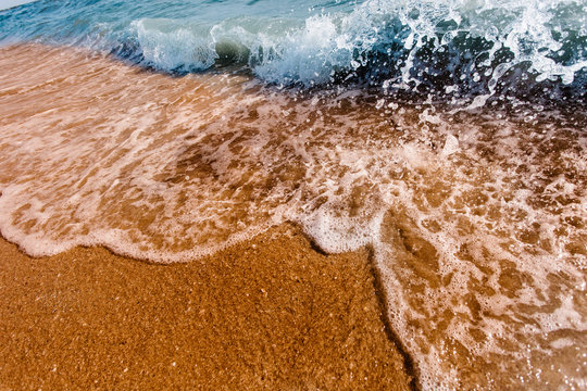 Waves crashing onto the sand