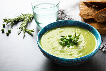 Fresh vegetable detox soup made of green peas in dish served on table. Space for text