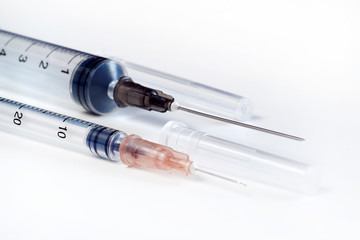 Disposable syringe. Plastic insulin syringe. The insulin syringe with the lid open shows sharp needles. Injection medicine. Medical equipment.