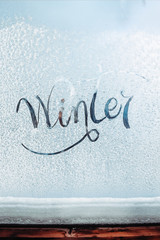 Inscription Hello Winter on a frozen window