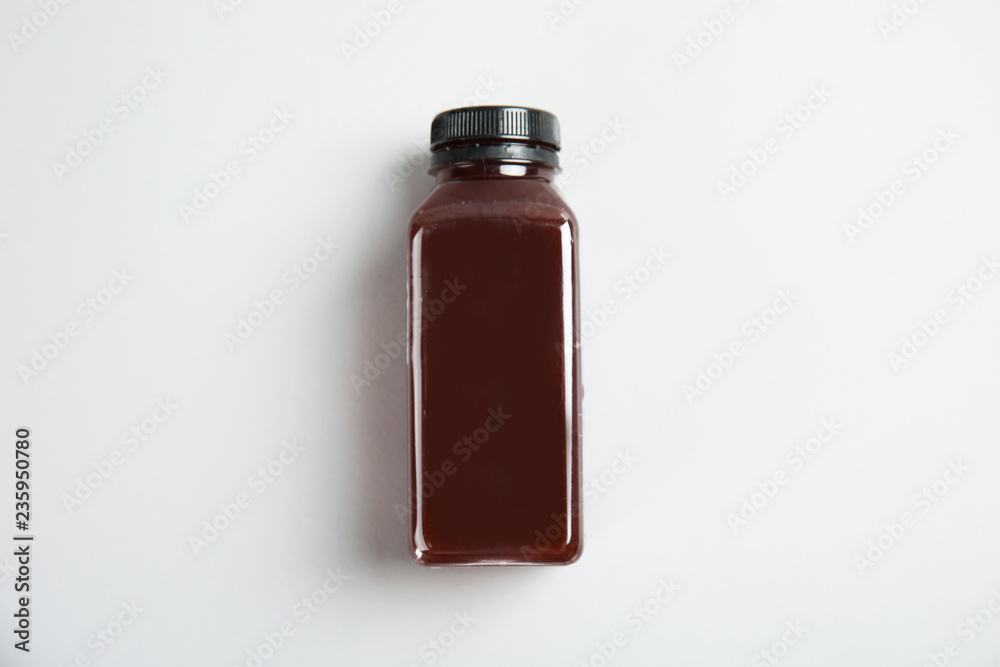 Poster One bottle with tasty drink on color background, top view