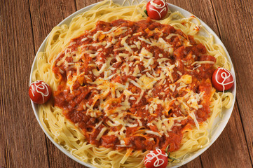 handmade pasta in tomato sauce with spices and vegetables in cheese breaded, decorated with parsley and cherry tomatoes