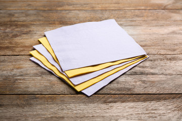 Clean paper napkins on wooden background. Personal hygiene