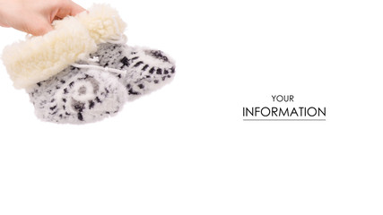 baby's bootees fur warming in female hands pattern on a white background isolation