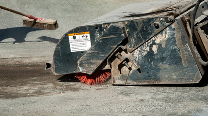 Sweeper attachments mini excavator. The sweeper sweeps, collects and dumps dirt and debris.