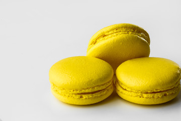French macarons. Stack of yellow lemon macaron on white background. Colorful macaroons
