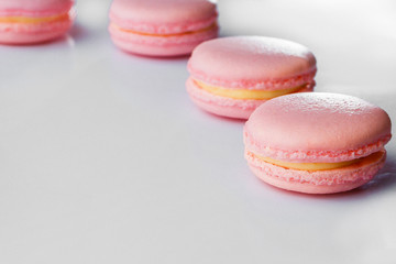French macarons. Stack pink rose macaron on white background. Colorful macaroons