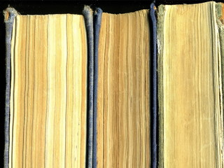 Yellowed pages of the old dilapidated book. Old book.