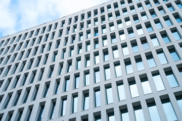 Office building windows background. Abstract geometrical pattern formed by architectural elements. Concrete modular structure. Contemporary building.