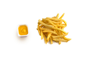 French fries on a white background. A pile of finished french fries close-up on a white background. Near the plastic container with cheese sauce.