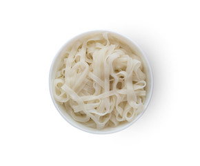 Rice noodles in a plate. Boiled rice noodles in a plate on a white background.Top view