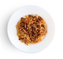 Noodles wok on a white plate. Rice noodles cooked in wok on a white plate.