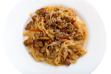 Noodles wok on a white plate. Rice noodles cooked in wok on a white plate.