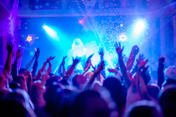 Fototapeta na wymiar crowd of people dancing in disco club
