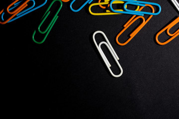color paperclip on black background