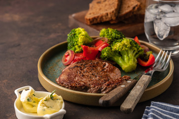 Grilled Beef steak with vegetables. Meat with grilled bell pepper, broccoli and onions