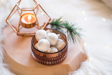 Festive Christmas white balls decoration with candle on wooden board