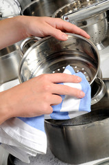 WOMAN DRYING POTS AND PANS