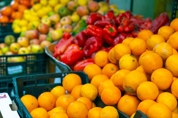 Street  fruit and vegetables market. Oranges, peppers, apples, kakis. Bad organge...Shallow depth of field, focus on oranges..