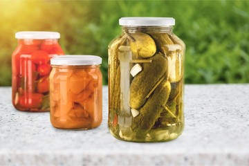Jars with canned vegetables isolated on white