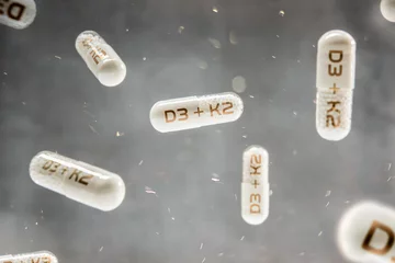 Photo sur Plexiglas K2 Pills float in the air with inscription D3 + K2 vitamins