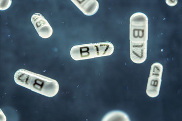 Pills float in the air with inscription B17 vitamin