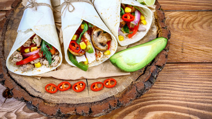 Burritos with minced meat and fresh vegetables close-up on the table. Dieting and weight loss concept