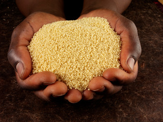 MAN'S HANDS HOLDING COUSCOUS