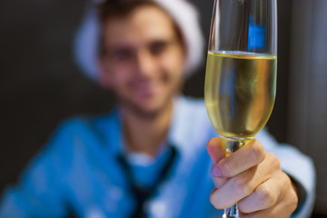businessman smiling with glass of champagne in the office