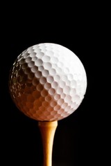 Close Up of Golf Ball on Tee, Isolated on Black Background