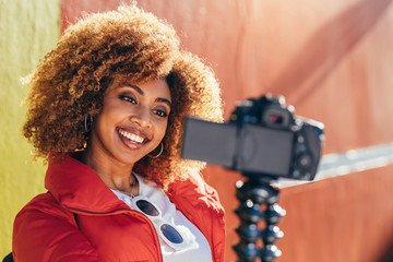 Smiling female blogger shooting for her video blog