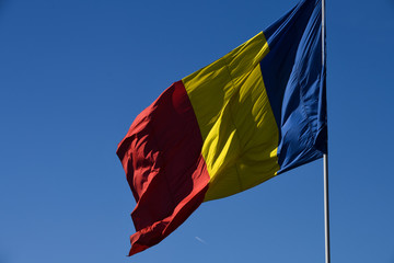 Romanian national flag in the wind on a sunny day.