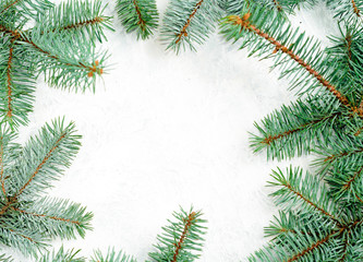 Christmas frame made of branches of a New Year tree. Christmas wallpaper. Flat lay, top view, copy space
