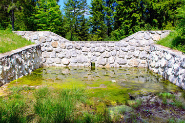 An example of a dry dam (cross section) constructed in Slovenia. Its purpose is flood control. The dam holds back the excess water, releasing it downstream at a controlled rate.