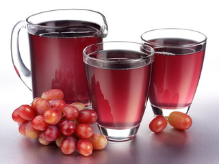 GLASS AND JUG OF RED GRAPE JUICE