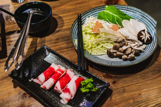 Hot Pot set on a wooden taple in a Korean restaurant