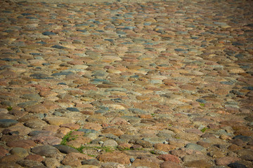 old paving of cobblestones. Stone pavement.