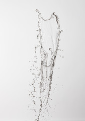Fototapeta na wymiar water splash with a lot of drops on a gray background