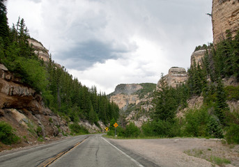 Road with falling rocks sign