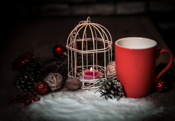 closeup.red Cup and candle at the Christmas holiday table