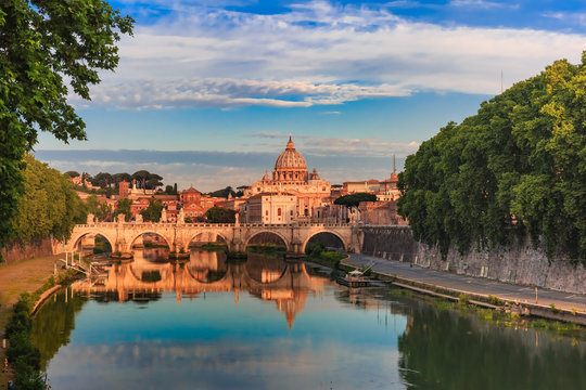 Saint Peter Cathedral and Saint Angel bridge over the Tiber River in the morning in Rome, Italy.